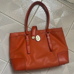 Orange Tumi Computer handbag with loads is pockage